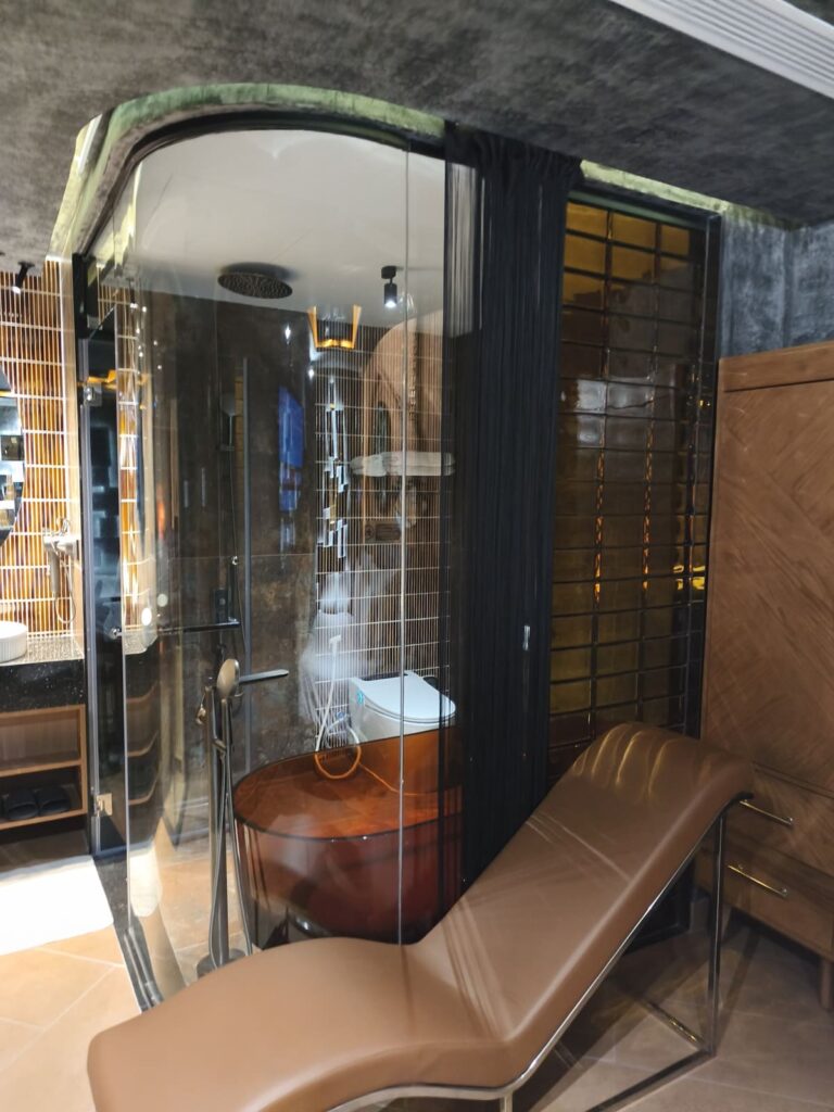 Bathroom with large tub and glass walls