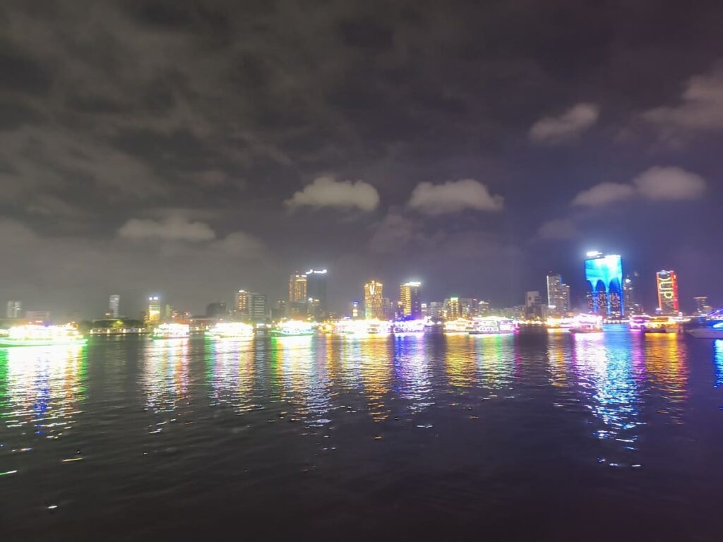Illuminated river with boats lined up