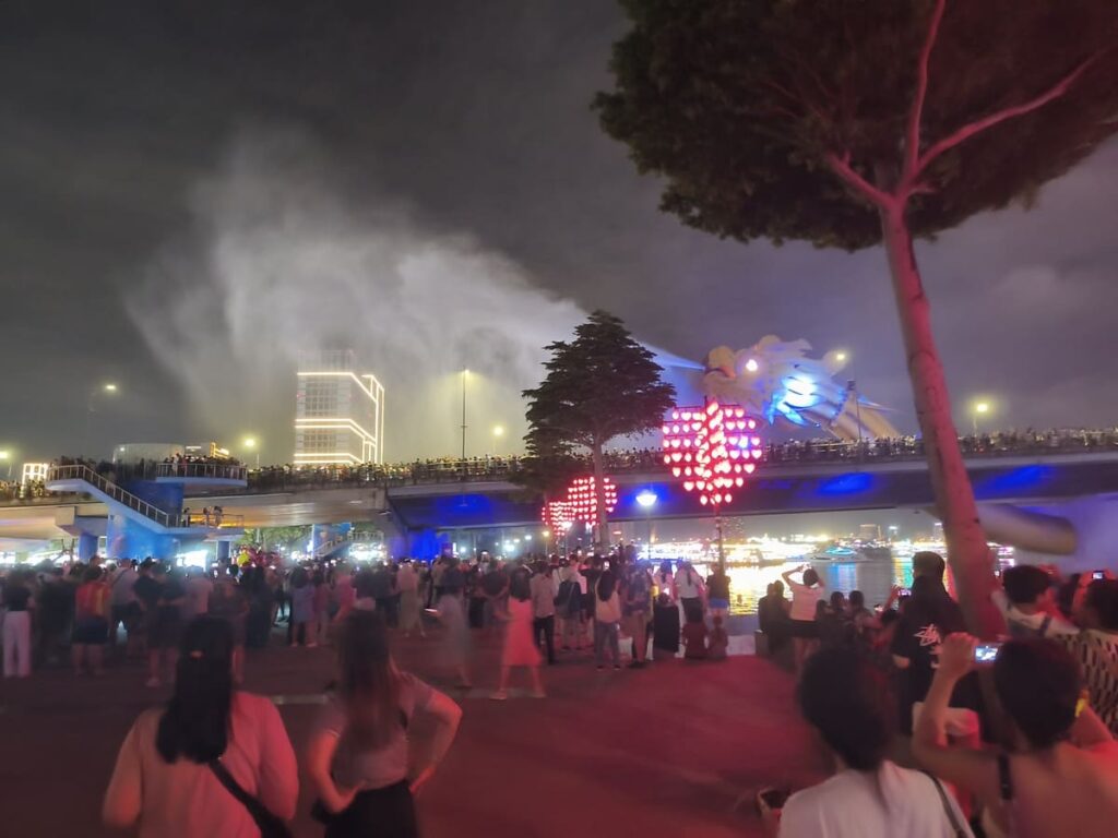 Big water fountain spewing out of dragon bridge