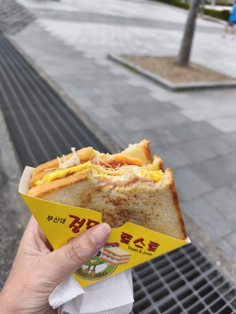 Hand holding a multi-layered sandwich