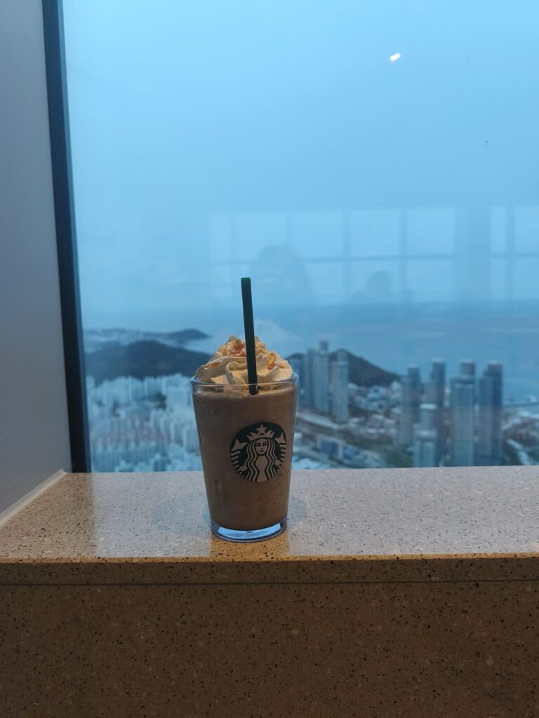 Caramel Frapucchino in front of window with Busan view
