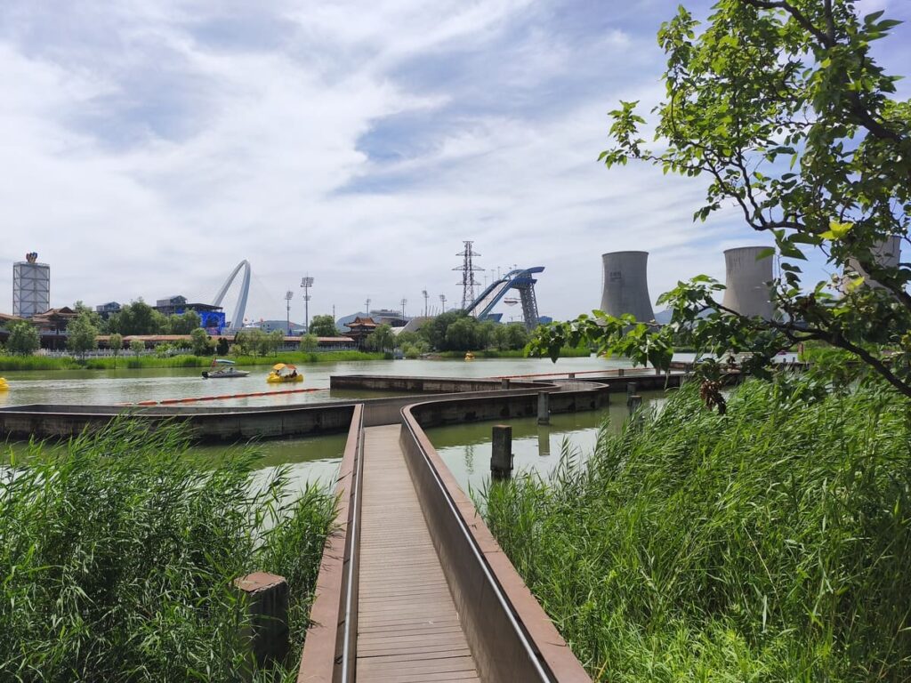 Walkway out to lake with cooling towers in distance