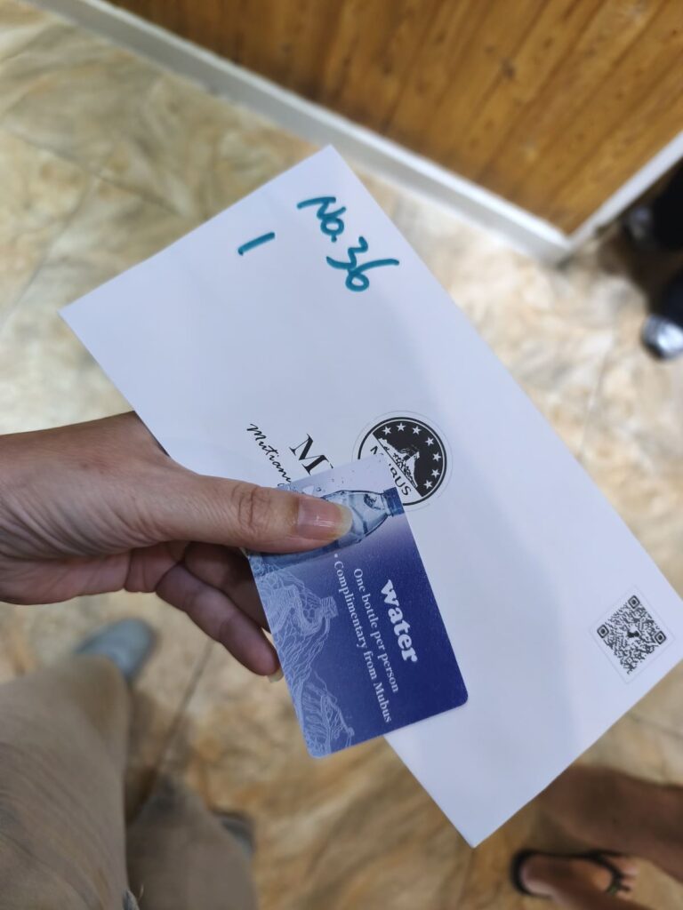 Envelope and coupon for water on MuBus Tour