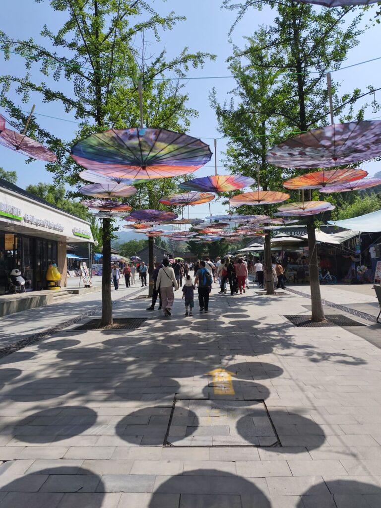 Wide walkway with umbrellas overhead at Mutianyu