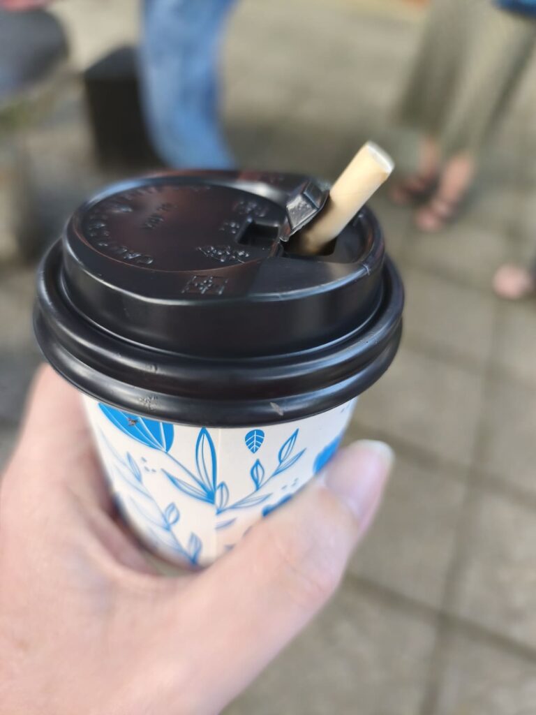 Hand holding a cup with coffee