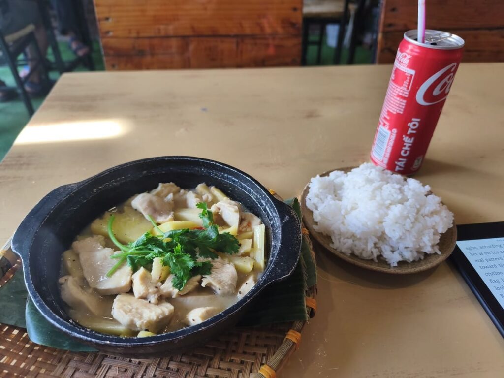 Table with soda, curry dish, and rice