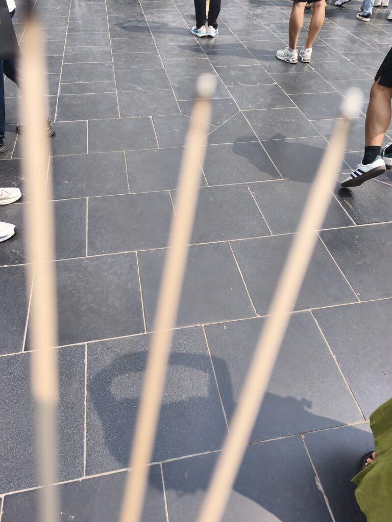 Three lighted incense sticks