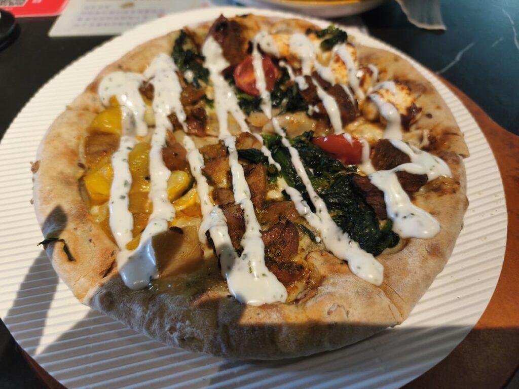 Pizza with white sauce on top