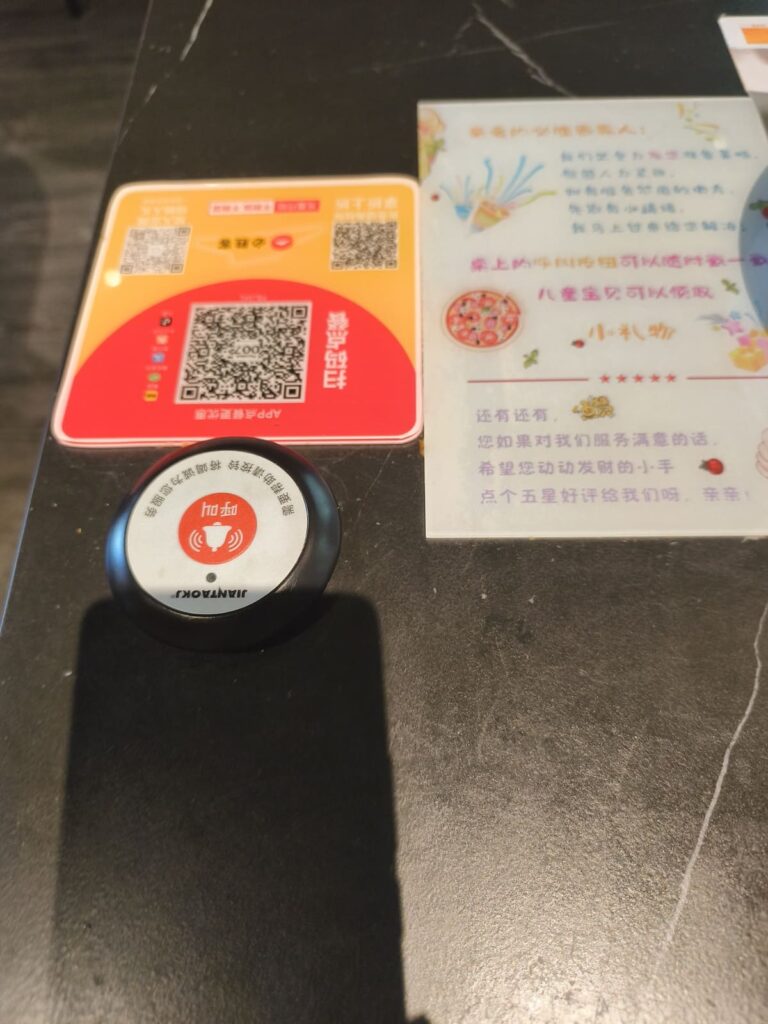 QR code and mystery button on Pizza Hut table
