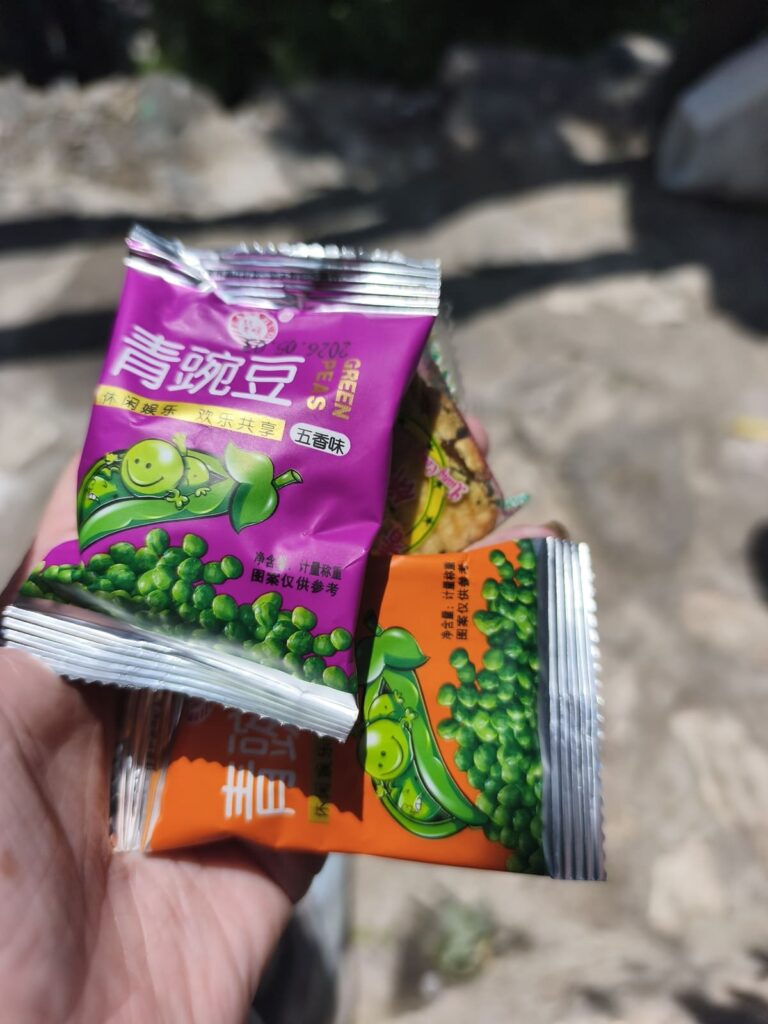 Hand holding small snack packets