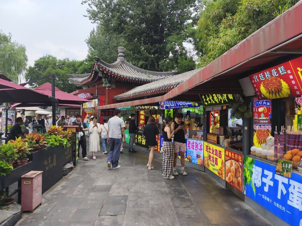 Busy pedestrian street with food stalls