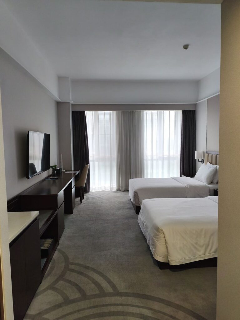Hotel room at CSN Pearl Hotel in Beijing with double beds