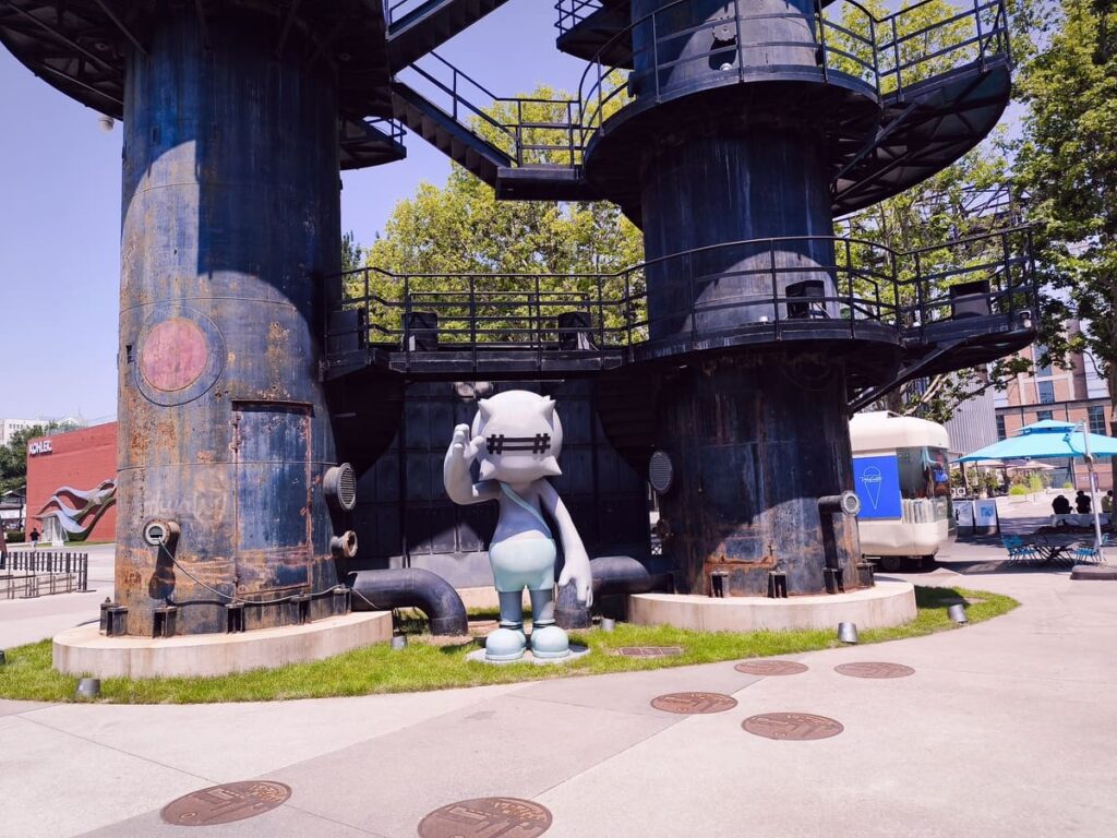 Metal pipe towers and statue