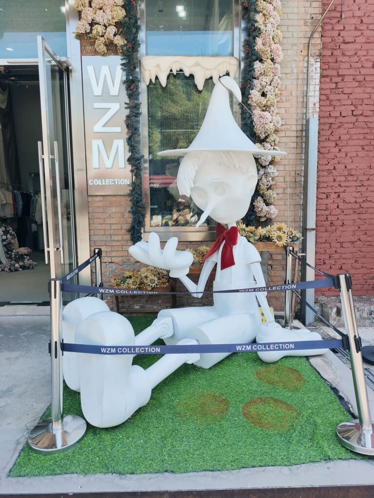 Large Pinocchio figure in front of store