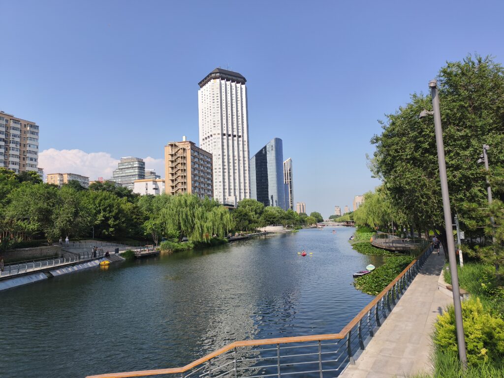 River in Sanlitung with path next to it