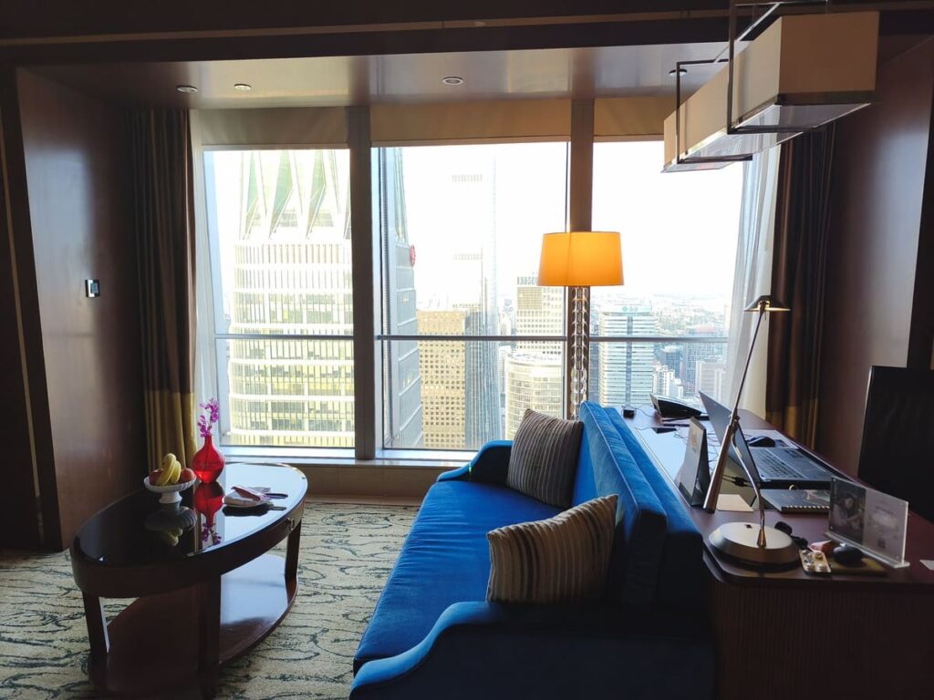 Hotel room at China World Summit Wing with desk and view