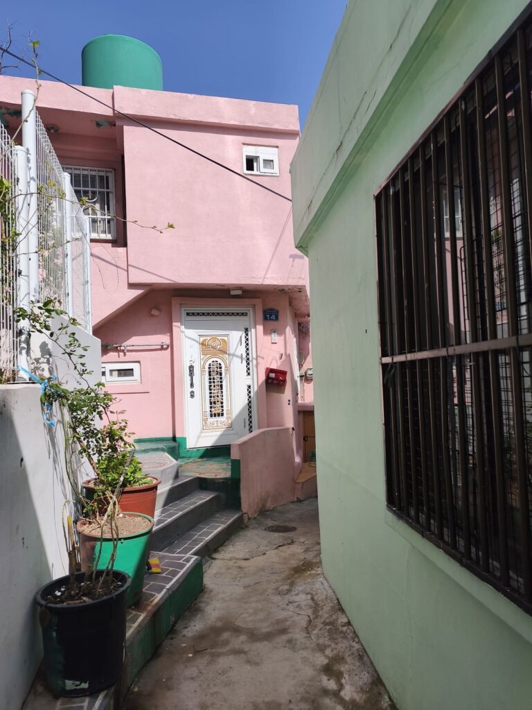 Narrow alley with pink and green houses in Busan